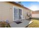 Exterior patio with a sliding glass door, small plants, a white chair and hammock at 288 Garland, Deltona, FL 32725