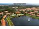 Stunning aerial view of the community with a serene lake and lush landscaping at 3018 Red Ginger Rd, Kissimmee, FL 34747