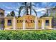 Welcoming entrance to Encantada with a decorative lizard fountain, lush landscaping, and CLC Worldwide signage at 3018 Red Ginger Rd, Kissimmee, FL 34747