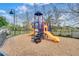 Community playground with slides, climbing stairs and black metal safety fence at 3018 Red Ginger Rd, Kissimmee, FL 34747