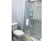 Clean bathroom featuring a glass-enclosed shower with tiled walls at 3018 Red Ginger Rd, Kissimmee, FL 34747