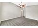 Neutral bedroom with grey floors, a ceiling fan and ample space at 3288 Brewster Dr, Kissimmee, FL 34743