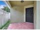 A tiled front entryway featuring a black front door and a white lattice fence at 3288 Brewster Dr, Kissimmee, FL 34743