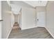 Inviting hallway with gray wood-look floors and a white front door, freshly painted in neutral colors at 3288 Brewster Dr, Kissimmee, FL 34743