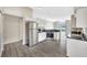 Modern kitchen with stainless steel appliances and gray wood-look flooring, featuring updated cabinets at 3288 Brewster Dr, Kissimmee, FL 34743