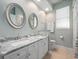 Bathroom featuring a dual sink vanity and a framed mirror and white cabinets at 3369 Park Grove Ct, Longwood, FL 32779