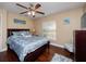 Bedroom with hardwood floors, ceiling fan, and a comfortable bed at 3369 Park Grove Ct, Longwood, FL 32779