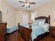 Bedroom with wooden furniture, ceiling fan, and decorated with sea-themed decor at 3369 Park Grove Ct, Longwood, FL 32779