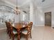 Elegant dining room features a wooden table with seating for eight and a decorative chandelier at 3369 Park Grove Ct, Longwood, FL 32779