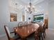 Elegant dining room with pool table visible through the doorway and decorative chandelier at 3369 Park Grove Ct, Longwood, FL 32779