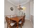 Elegant dining room features a wooden table with seating for eight and a decorative chandelier at 3369 Park Grove Ct, Longwood, FL 32779