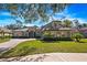 Charming home featuring mature landscaping, a barrel tile roof, and a side entry garage at 3369 Park Grove Ct, Longwood, FL 32779