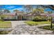 Stunning home featuring a barrel tile roof, a well manicured lawn and mature landscaping at 3369 Park Grove Ct, Longwood, FL 32779