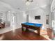 Spacious game room with a pool table, hardwood floors, and access to the outdoors at 3369 Park Grove Ct, Longwood, FL 32779