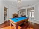 Open-concept game room with a pool table, hardwood floors, and views into other living spaces at 3369 Park Grove Ct, Longwood, FL 32779