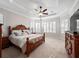 Large main bedroom with a tray ceiling and plenty of natural light from the multiple windows at 3369 Park Grove Ct, Longwood, FL 32779