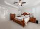 Spacious main bedroom with wood furniture, ceiling fan, and natural light from the window at 3369 Park Grove Ct, Longwood, FL 32779