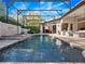 Sparkling screened-in pool with spa, cascading water feature, and ample lounge seating for outdoor relaxation at 3369 Park Grove Ct, Longwood, FL 32779