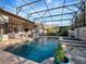 Inviting screened-in pool with a spa, cascading water feature, and an array of seating options on the patio at 3369 Park Grove Ct, Longwood, FL 32779