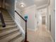 Traditional staircase featuring carpeted steps, a dark wood handrail, and tiled landing leading into the home at 3369 Park Grove Ct, Longwood, FL 32779