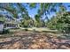 Overiew of large backyard with trees, lawn, and house at 390 Lake Geneva Rd, Geneva, FL 32732