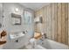 Bathroom with wood panel accents, sink, toilet, and shower-tub at 390 Lake Geneva Rd, Geneva, FL 32732