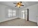 Cozy bedroom with ceiling fan and natural light from the lace curtained window at 390 Lake Geneva Rd, Geneva, FL 32732