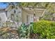 The exterior of this cozy home shows the entrance and surrounding foliage at 390 Lake Geneva Rd, Geneva, FL 32732