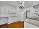 This kitchen features wood floors, white cabinets and a refrigerator at 390 Lake Geneva Rd, Geneva, FL 32732