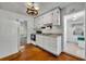 This kitchen features wood floors, white cabinets and an oven and range combo at 390 Lake Geneva Rd, Geneva, FL 32732