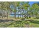 Beautiful lake view through mature trees creates a tranquil setting at 390 Lake Geneva Rd, Geneva, FL 32732