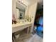 Bathroom with white sink, marble floors, spa themed artwork and floral accents at 402 Cypress Dr # 402, Haines City, FL 33844