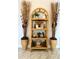 Rattan shelf decorated with eclectic decorations and plants, adding charm and character to the home at 402 Cypress Dr # 402, Haines City, FL 33844