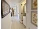 Hallway with light colored floors leading to the living room and a small laundry room at 402 Cypress Dr # 402, Haines City, FL 33844