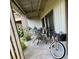 Covered patio with outdoor seating, a bicycle, and potted plants for relaxing outdoor living at 402 Cypress Dr # 402, Haines City, FL 33844