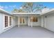 Covered back porch with French doors, neutral paint, and space for outdoor lounging and entertaining at 4029 Cool Water Ct, Winter Park, FL 32792