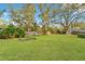 Expansive backyard with lush green lawn and well-maintained landscaping, perfect for outdoor activities at 4029 Cool Water Ct, Winter Park, FL 32792