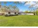 Expansive backyard with lush green lawn and well-maintained landscaping, perfect for outdoor activities at 4029 Cool Water Ct, Winter Park, FL 32792