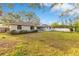 Beautiful backyard featuring a lush lawn, mature trees, and a wooden fence for privacy and shade at 4029 Cool Water Ct, Winter Park, FL 32792