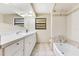 Bright bathroom showcasing a bathtub, shower, and sink with quartz countertops at 4029 Cool Water Ct, Winter Park, FL 32792