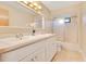 Bathroom featuring dual sinks, white cabinetry, quartz countertops, and a shower at 4029 Cool Water Ct, Winter Park, FL 32792