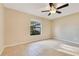 Bedroom featuring a ceiling fan and large window at 4029 Cool Water Ct, Winter Park, FL 32792