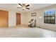 Bright bedroom featuring a ceiling fan, chair, and large window at 4029 Cool Water Ct, Winter Park, FL 32792