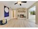 Spacious living room with wood floors, a stone fireplace, and ample natural light creating a warm and inviting atmosphere at 4029 Cool Water Ct, Winter Park, FL 32792