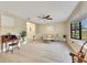 Bright living room featuring neutral paint, laminate flooring, a ceiling fan, and a large bay window at 4029 Cool Water Ct, Winter Park, FL 32792