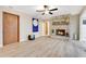 Living room features wood floors, a stone fireplace, and natural light, creating a cozy and inviting gathering space at 4029 Cool Water Ct, Winter Park, FL 32792