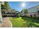 Serene backyard featuring a well-kept lawn, brick pathway, and a stylish storage shed with a yellow door at 428 Highland Ave, Orlando, FL 32801