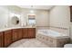 Bathroom with corner tub with decorative tile, double sinks, and natural light at 428 Highland Ave, Orlando, FL 32801