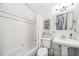 Clean and bright bathroom with white tile, a bathtub, and a pedestal sink at 428 Highland Ave, Orlando, FL 32801