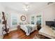 Cozy bedroom featuring a ceiling fan, natural light, and hardwood floors at 428 Highland Ave, Orlando, FL 32801